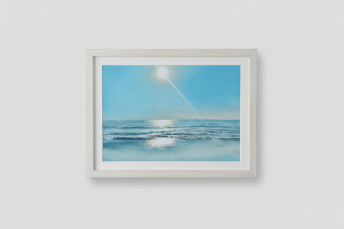 Framed artwork of a beach scene with a blue sky and sun.